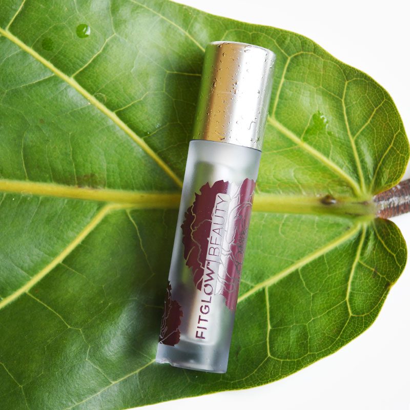Fitglow Night Lip Serum, pictured on a fig leaf, best nighttime clean lip balms
