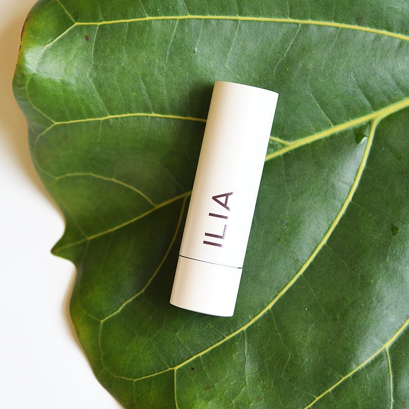 Ilia Balmy Tint, pictured on a fig leaf, best tinted clean lip balms