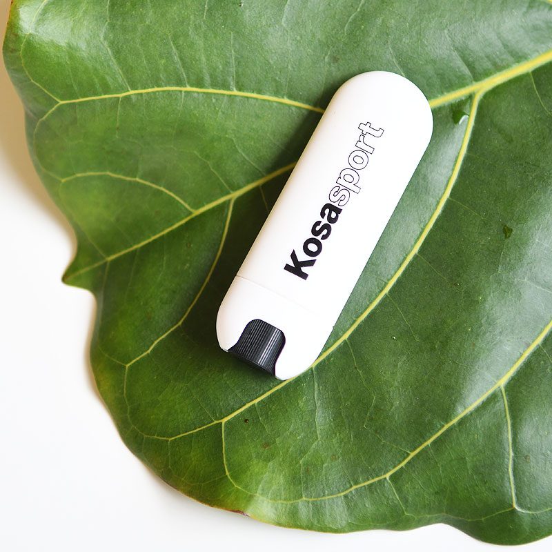Kosas Lipfuel, clean chapstick, pictured on a fig leaf, best daytime clean lip balms