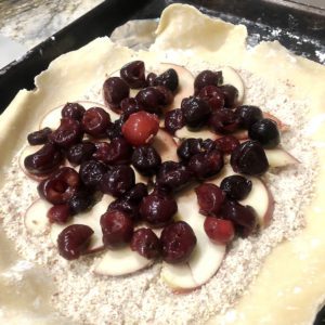 Cherry-Apple Almond Galette, on a cookie sheet before folding up the pie crust edge