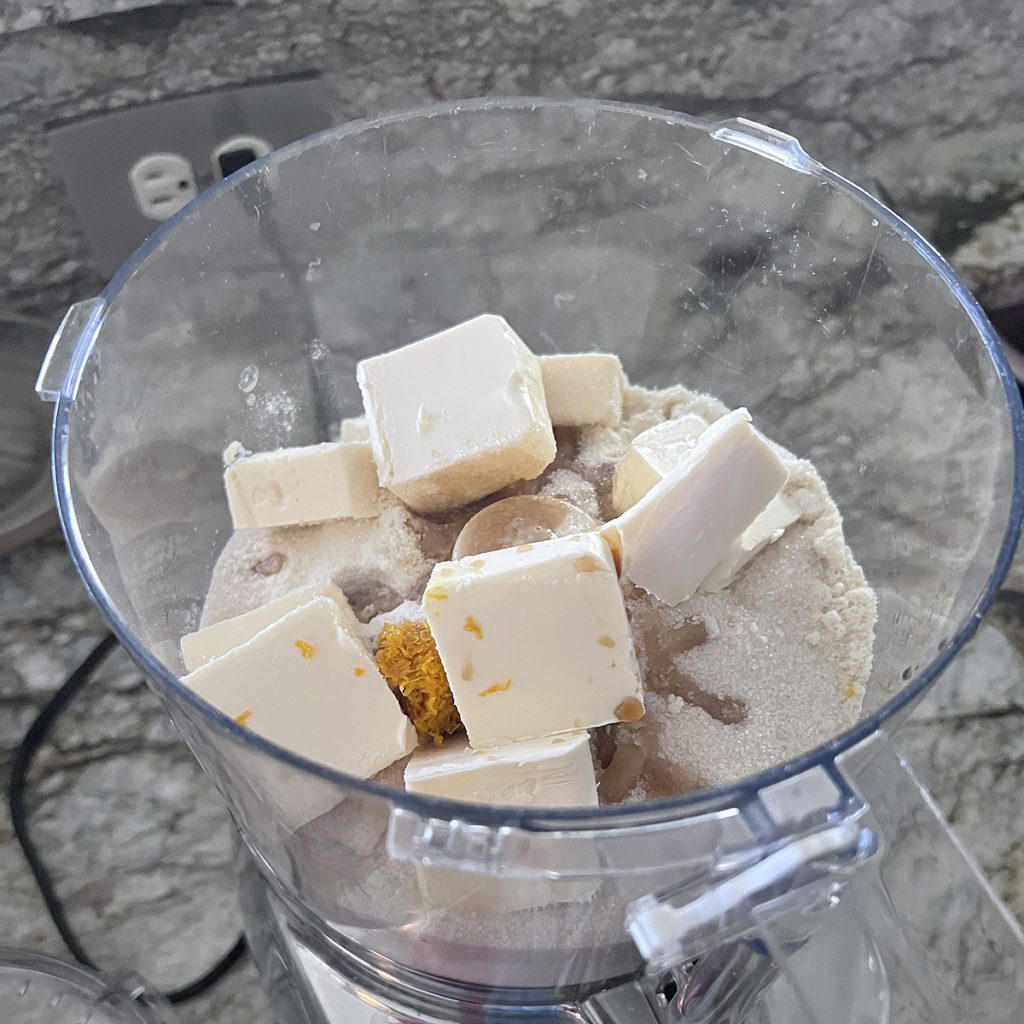 Making the shortbread biscuit recipe, all of the ingredients in the food processor before pulsing.