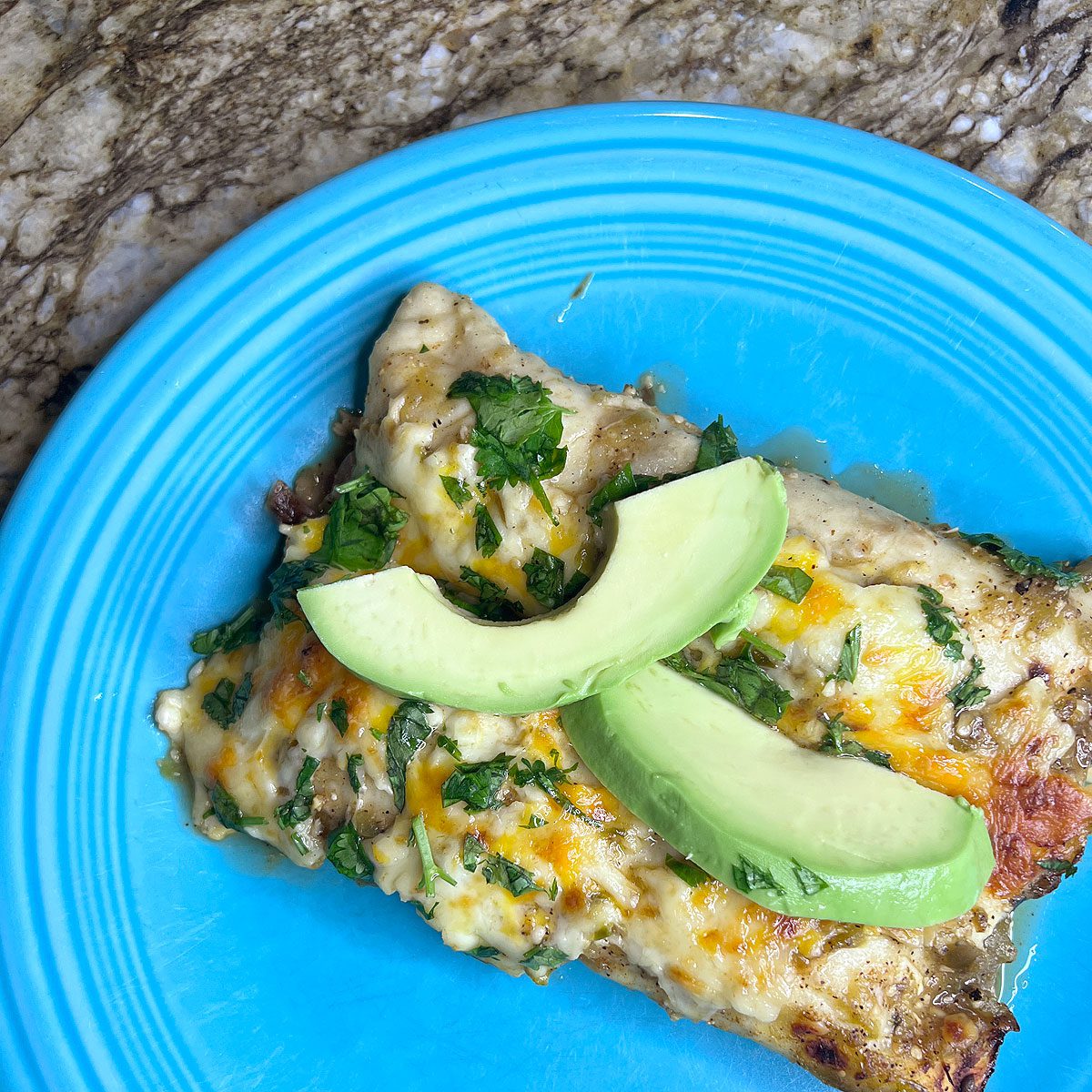 Hatch Honey Lime Chicken Enchiladas, plated on a turquoise Fiestaware dish